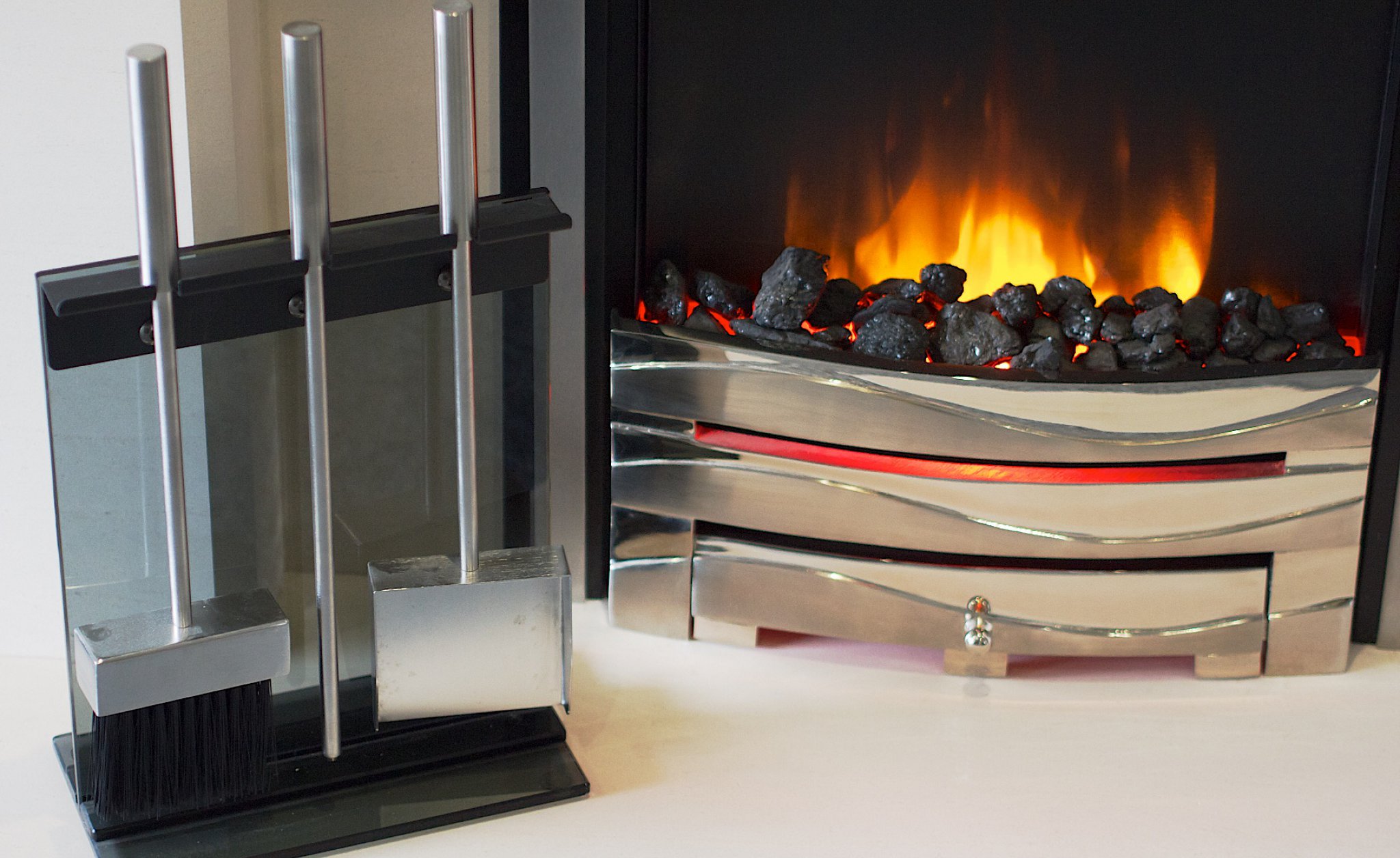 An electric fire with companion set