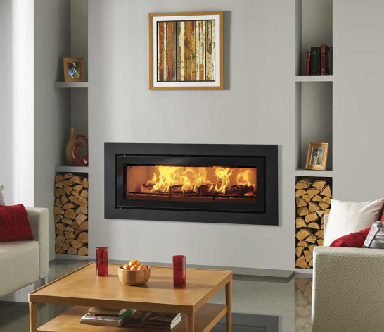 Modern wide inset wood-burning stove set into a chimney breast in a contemporary living room