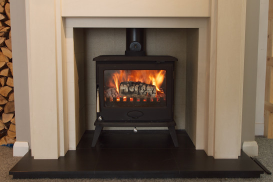 A Newman wood burning stove burning efficiently with kiln dried logs
